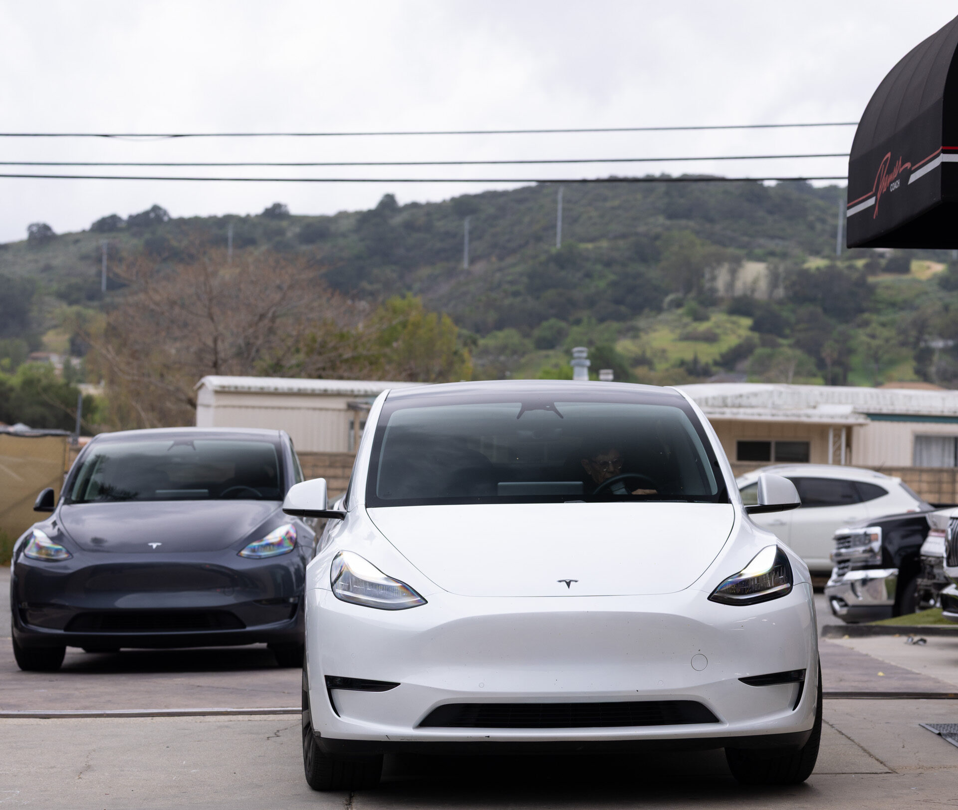 Tesla vehicles awaiting bumper repair at Premier Coach Auto Collision